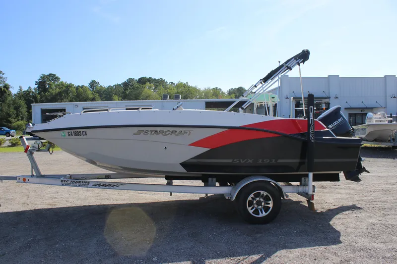 Slide: The Image of 2021 Starcraft SVX 191 OB boat on trailer, featuring sleek design and Suzuki outboard motor. - 14
