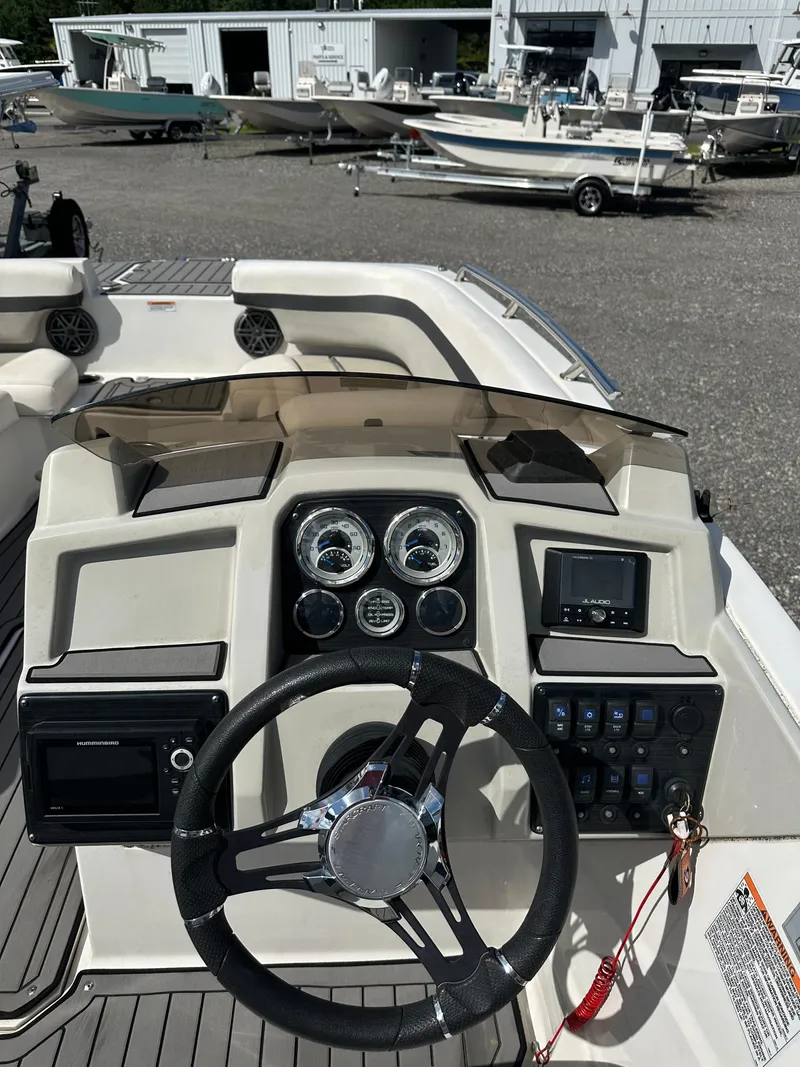 Slide: The Image of 2021 Starcraft SVX 191 OB boat dashboard with steering wheel and control panel. - 19