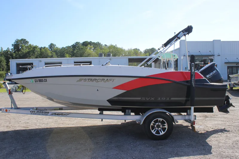 Slide: The Image of 2021 Starcraft SVX 191 OB boat on trailer, side view, outdoors. - 2