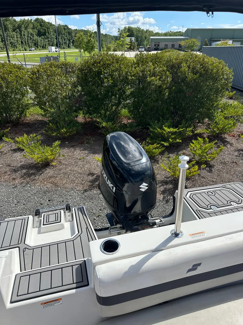 Slide: The Image of 2021 Starcraft SVX 191 OB boat with Suzuki outboard motor, docked near greenery. - 20