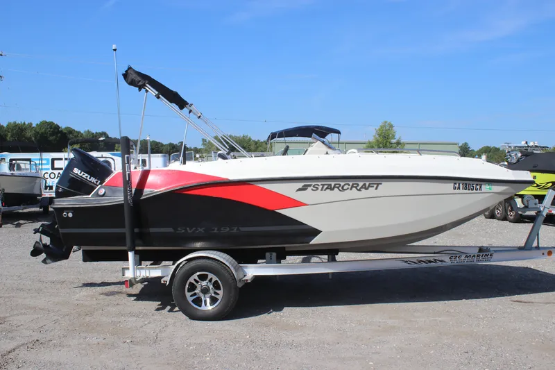 Slide: The Image of 2021 Starcraft SVX 191 OB boat on trailer, featuring Suzuki outboard motor. - 21