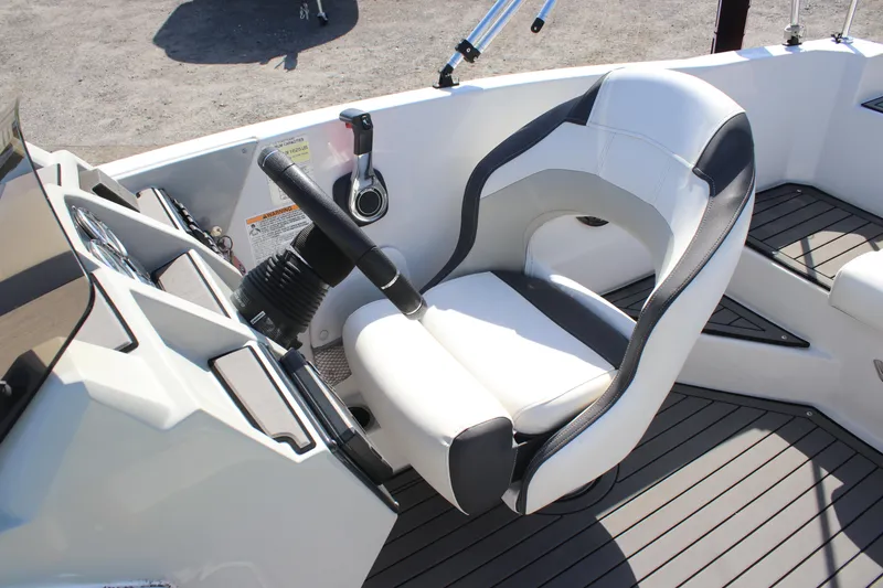 Slide: The Image of 2021 Starcraft SVX 191 OB boat interior with steering wheel and captain's chair. - 7