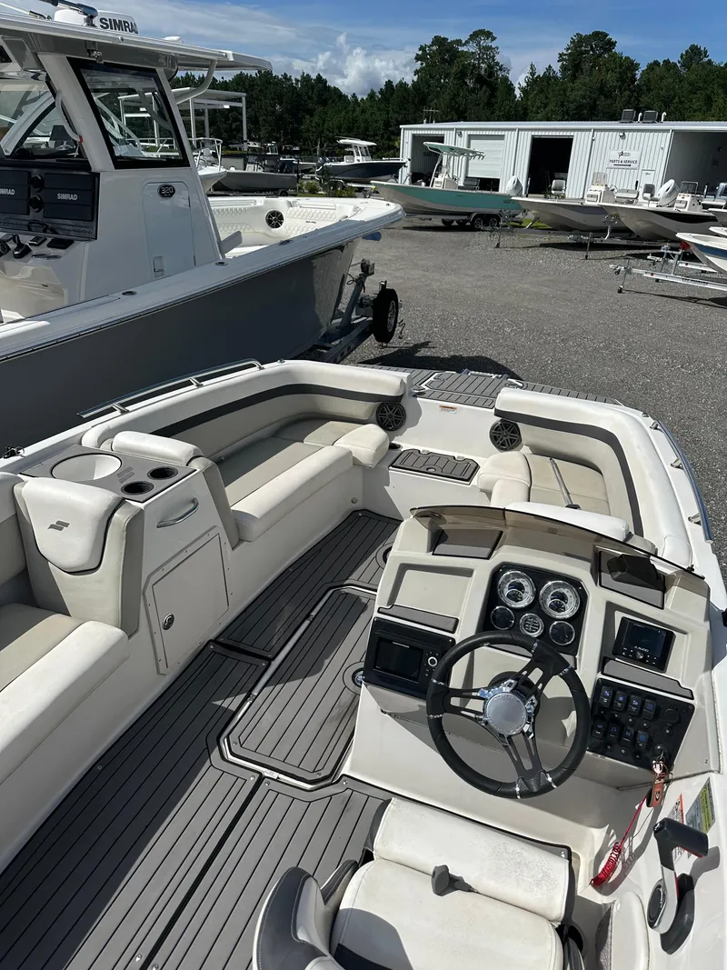 Slide: The Image of 2021 Starcraft SVX 191 OB boat interior with steering wheel and seating area. - 9