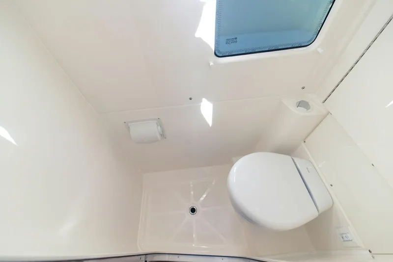 Slide: The Image of Interior of 2025 Solace 37 CS boat bathroom with toilet and window. - 18
