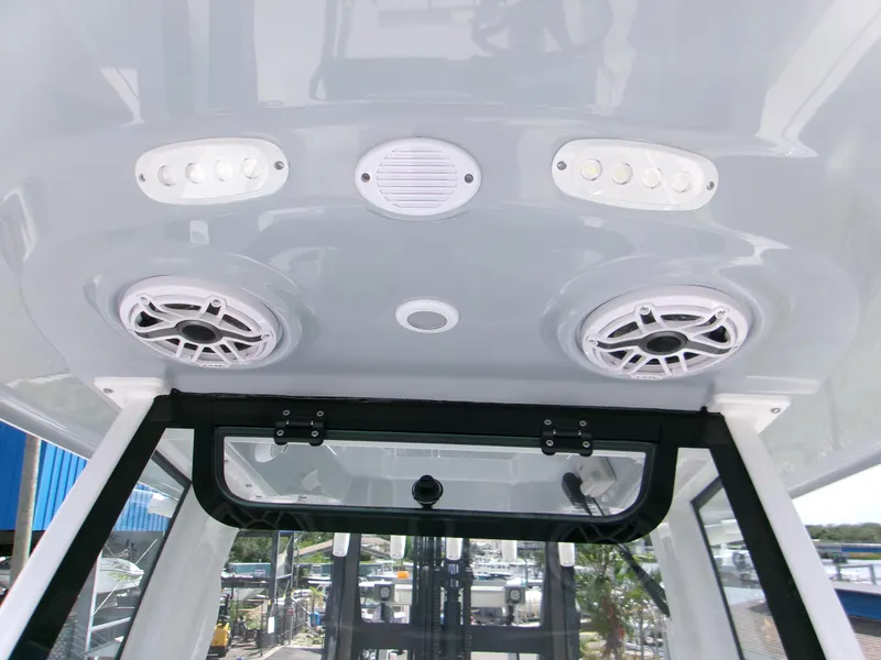 Slide: The Image of 2026 Sportsman Open 232 Center Console boat speakers and lights on the ceiling. - 12