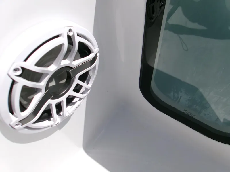 Slide: The Image of White speaker and window on 2026 Sportsman Open 232 Center Console boat. - 14