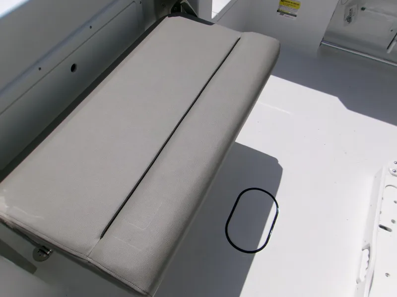 Slide: The Image of 2026 Sportsman Open 232 Center Console boat seat, gray upholstery, white deck. - 15