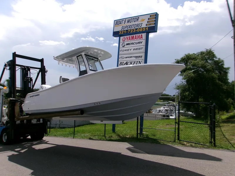 Slide: The Image of 2026 Sportsman Open 232 Center Console boat lifted by forklift at dealership. - 3