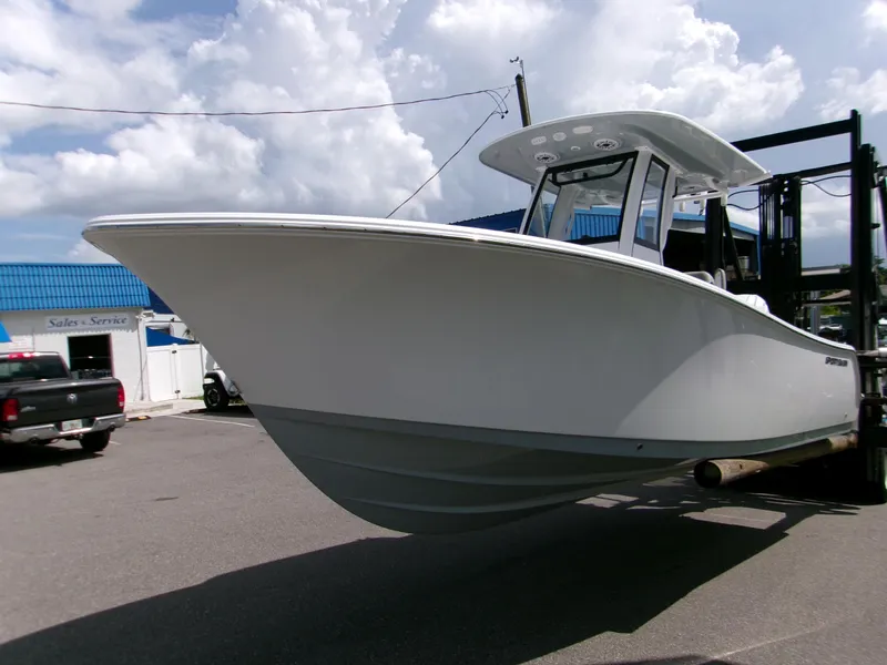 Slide: The Image of 2026 Sportsman Open 232 Center Console boat on display at a dealership. - 4