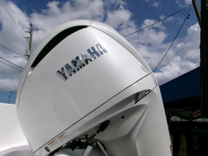Slide: The Image of Yamaha outboard motor on 2026 Sportsman Open 232 Center Console boat under blue sky. - 5