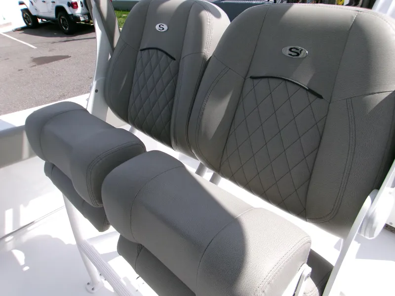 Slide: The Image of 2026 Sportsman Open 232 Center Console boat seats with gray upholstery and diamond stitching. - 9