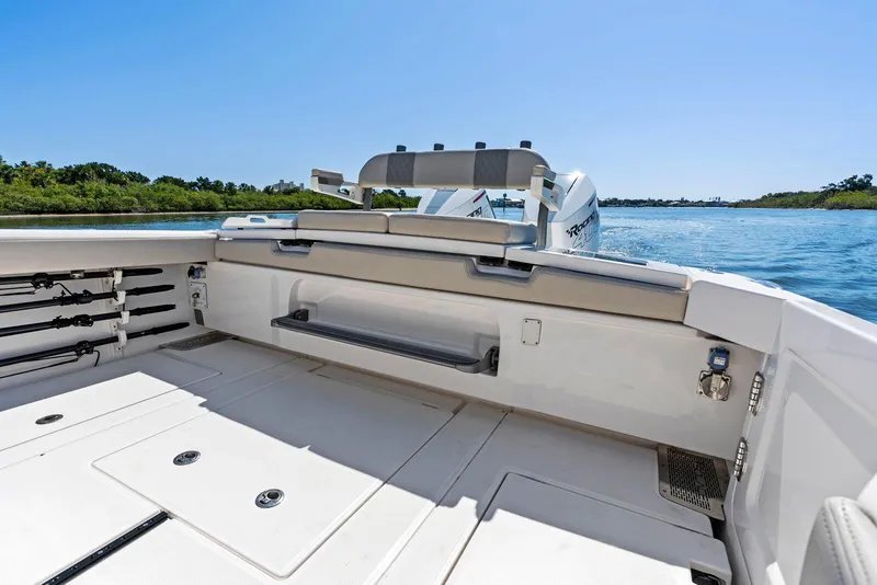 Slide: The Image of 2025 Solace 32 CS boat deck with seating, on a sunny day by the water. - 6