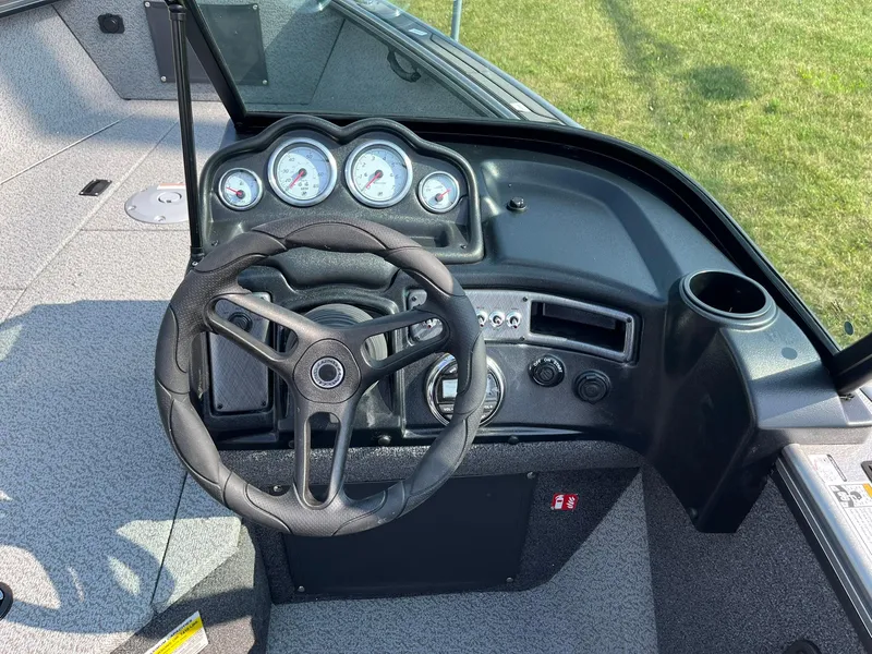 Slide: The Image of 2026 Lund 2075 Fisherman boat dashboard with steering wheel and gauges. - 20