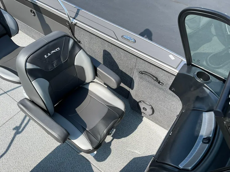 Slide: The Image of 2026 Lund 2075 Fisherman boat interior with black and gray seating and console details. - 24