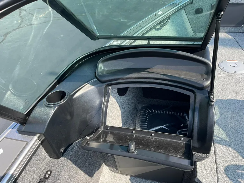 Slide: The Image of 2026 Lund 2075 Fisherman boat interior with open storage compartment and cup holder. - 26