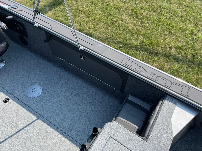 Slide: The Image of 2026 Lund 2075 Fisherman boat interior with seating and storage, viewed from above. - 27