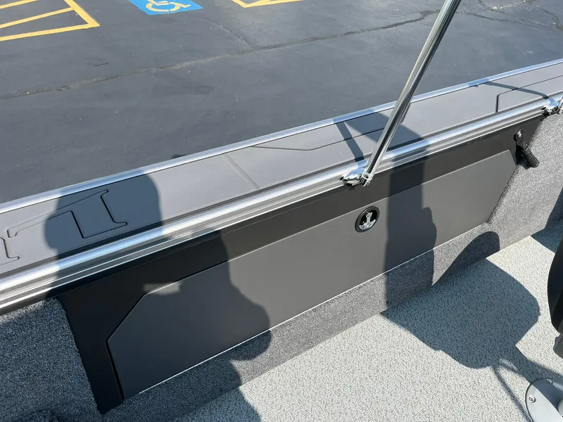 Slide: The Image of 2026 Lund 2075 Fisherman boat interior with storage compartment and shadows. - 30