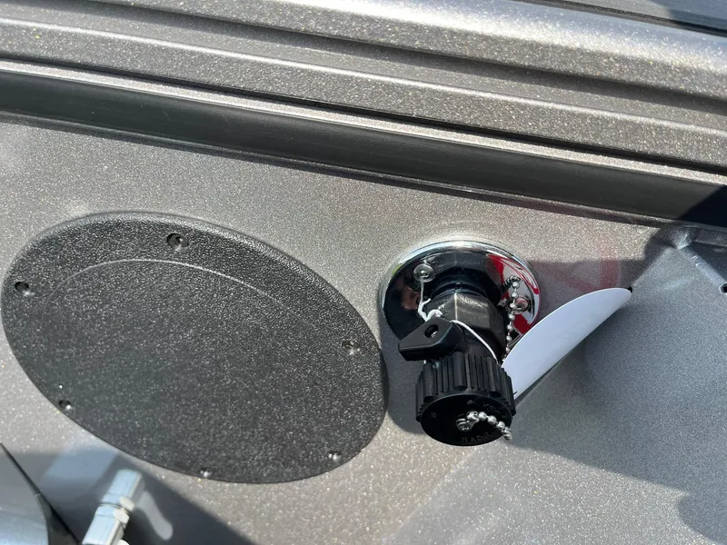 Slide: The Image of Close-up of a 2026 Lund 2075 Fisherman boat's fuel cap and vent on a metallic surface. - 38