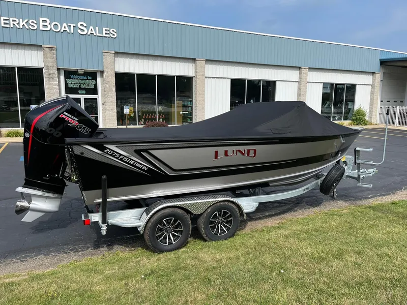Slide: The Image of 2026 Lund 2075 Fisherman boat on trailer outside dealership. - 41