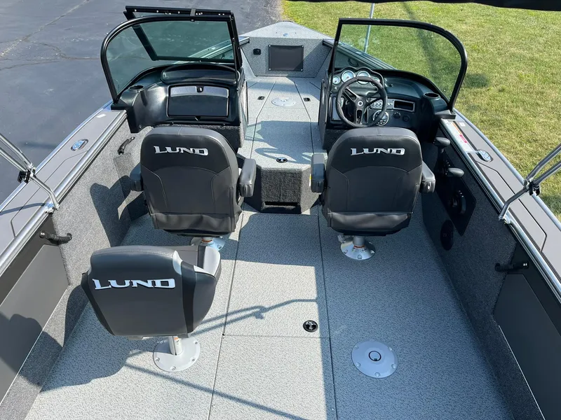 Slide: The Image of 2026 Lund 2075 Fisherman boat interior with two seats and steering console. - 6