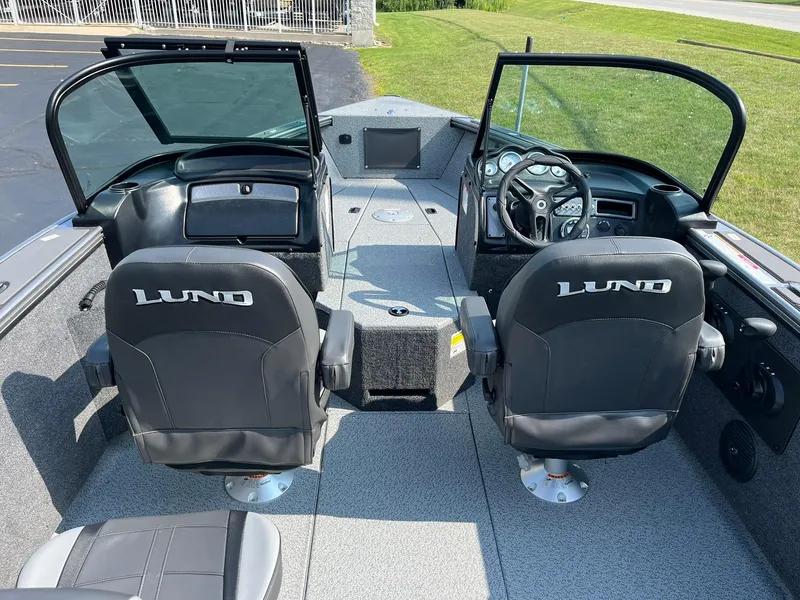 Slide: The Image of 2026 Lund 2075 Fisherman boat interior with dual seats and steering console. - 7