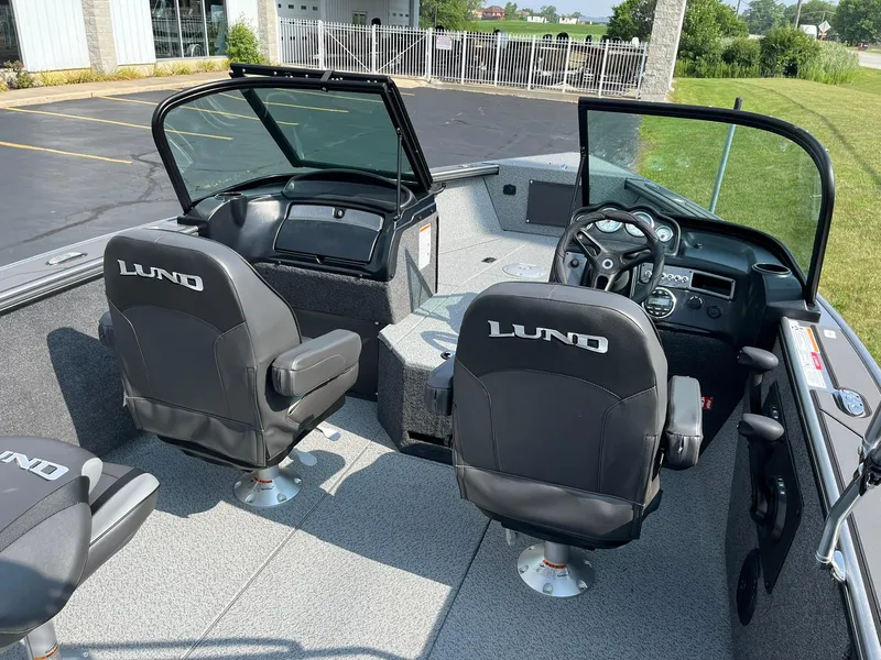 Slide: The Image of 2026 Lund 2075 Fisherman boat interior with black seats and steering console. - 8