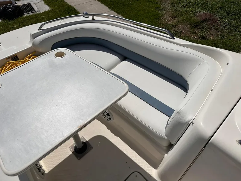 Slide: The Image of 2001 Bayliner 215 Deck Boat interior with seating and table. - 18