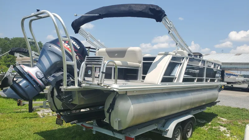 Slide: The Image of 2020 Starcraft EX 22 Q pontoon boat with Yamaha motor on trailer. - 2