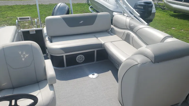 Slide: The Image of 2020 Starcraft EX 22 Q pontoon boat interior with gray seating and carpet. - 6