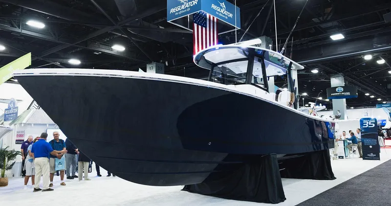 The Image of 2026 Regulator 35 boat on trailer, parked under palm trees, clear sky background. - 0