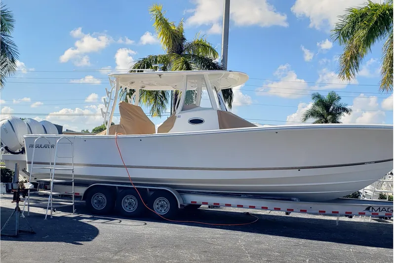 Slide: The Image of 2026 Regulator 35 boat with tan covers and rod holders on deck. - 11