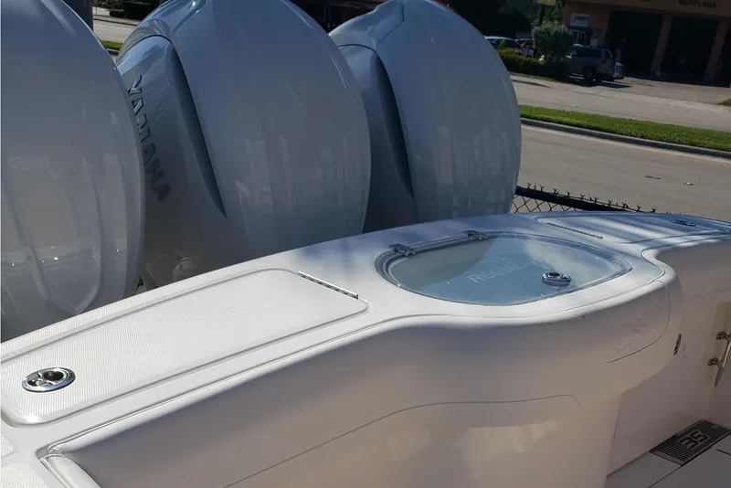 Slide: The Image of 2026 Regulator 35 boat with covered seating, docked under sunny skies. - 13