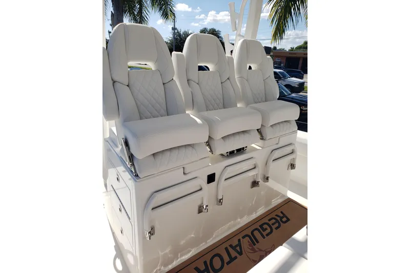 Slide: The Image of 2026 Regulator 35 boat seating with white quilted upholstery and armrests. - 23