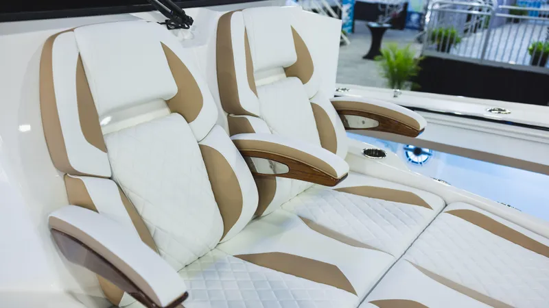 Slide: The Image of 2026 Regulator 35 boat with triple 350 V6 engines displayed at a boat show. - 4