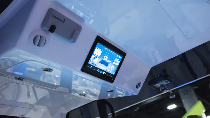 Slide: The Image of 2026 Regulator 35 boat with triple outboard engines, rear view under clear blue sky. - 9