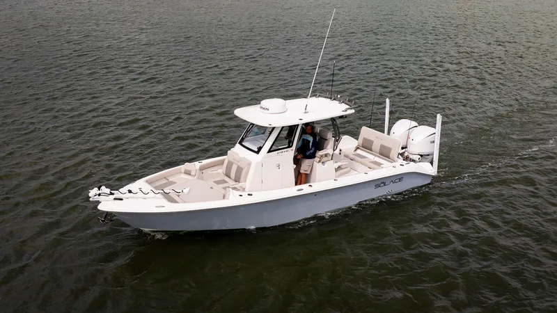 Slide: The Image of 2025 Solace 28 HCS boat cruising on open water, side view. - 0