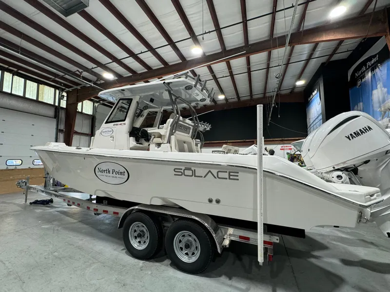 Slide: The Image of 2025 Solace 28 HCS boat on trailer in indoor showroom. - 12