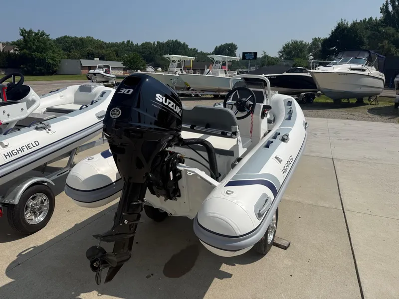 Slide: The Image of 2024 Highfield Classic 360 GT boat with Suzuki outboard motor on display. - 2