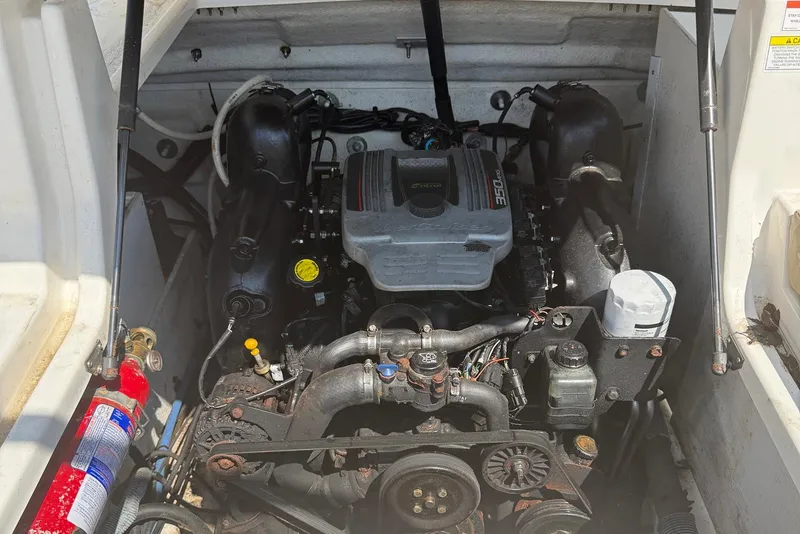 Slide: The Image of 2014 Sea Ray 240 Sundeck Outboard engine compartment with visible components and fire extinguisher. - 11