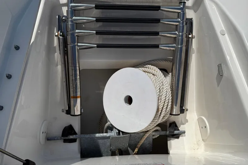Slide: The Image of 2014 Sea Ray 240 Sundeck Outboard anchor storage with rope and ladder. - 3