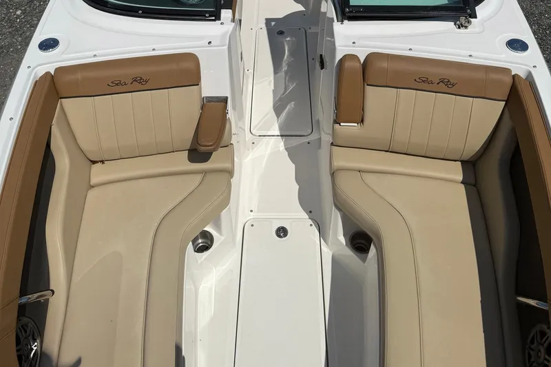 Slide: The Image of 2014 Sea Ray 240 Sundeck Outboard boat interior with tan seating and armrests. - 4