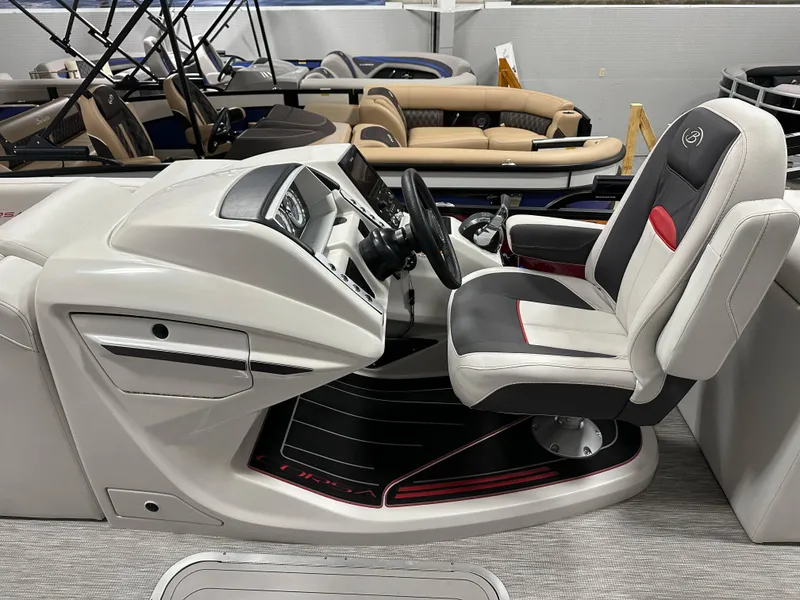 Slide: The Image of 2021 Barletta 23QCSS boat interior with captain's chair and control panel. - 20