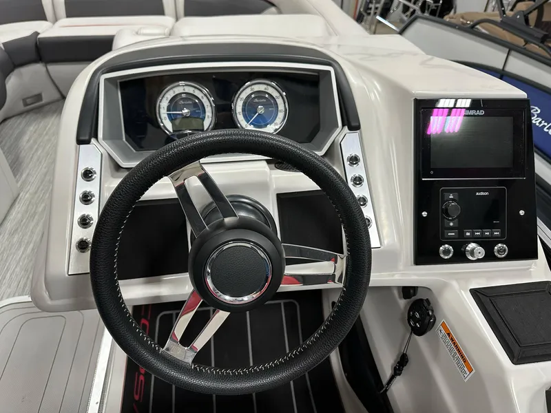 Slide: The Image of 2021 Barletta 23QCSS boat dashboard with steering wheel and control panel. - 22