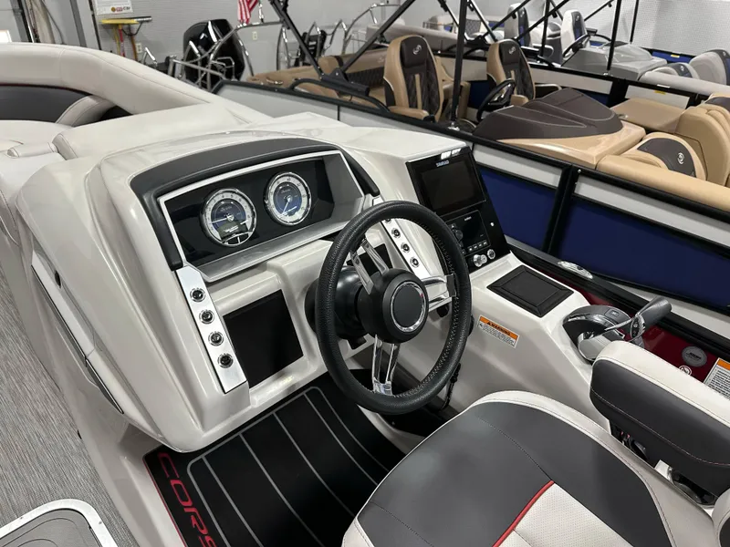 Slide: The Image of 2021 Barletta 23QCSS boat interior with modern dashboard and steering wheel. - 23