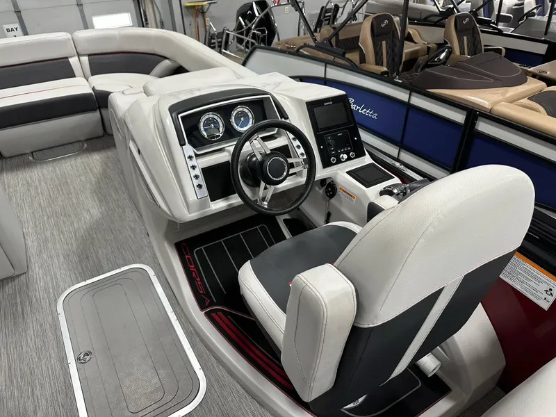 Slide: The Image of 2021 Barletta 23QCSS boat interior with steering console and seating area. - 30