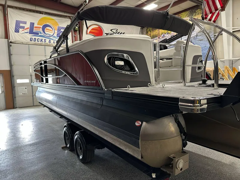 Slide: The Image of 2021 Barletta 23QCSS pontoon boat in showroom, featuring sleek design and modern amenities. - 4