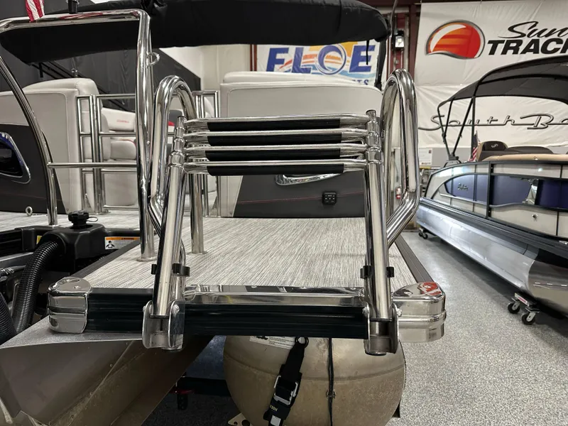 Slide: The Image of 2021 Barletta 23QCSS pontoon boat with stainless steel ladder and deck in showroom. - 9