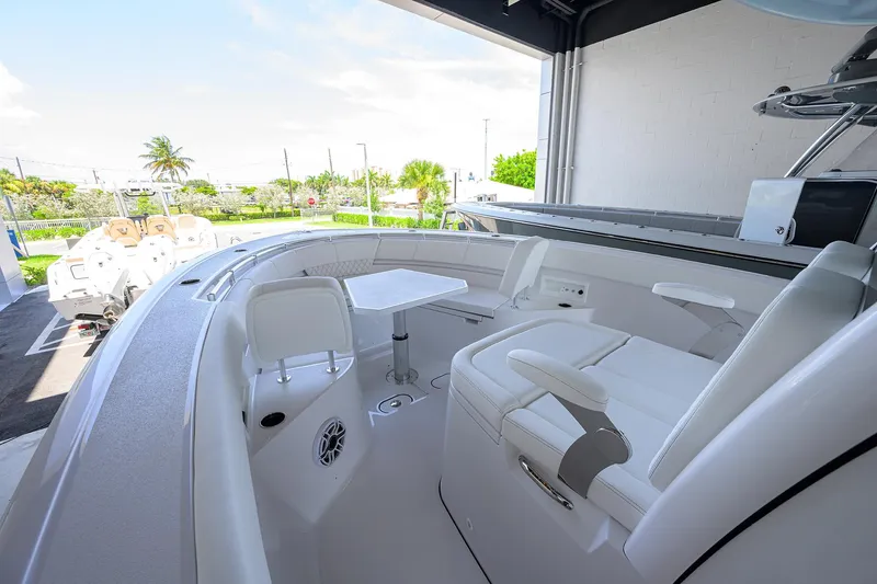 Slide: The Image of 2026 Sportsman Heritage 321 Center Console boat interior with seating and table. - 10