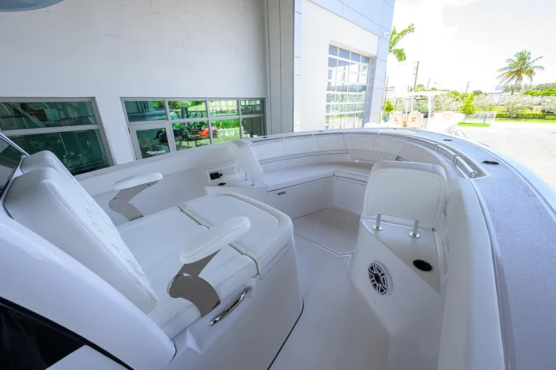 Slide: The Image of 2026 Sportsman Heritage 321 Center Console boat interior with white seating and modern design. - 11
