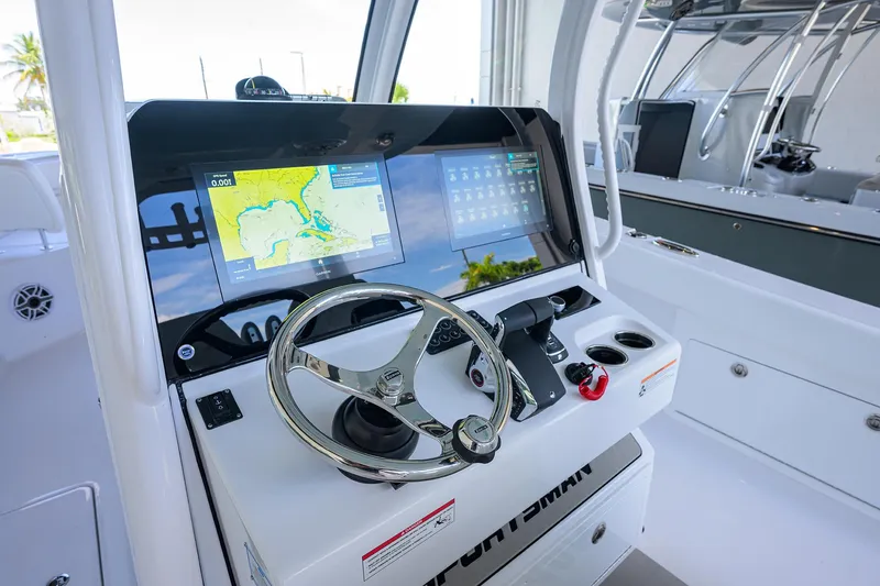 Slide: The Image of 2026 Sportsman Heritage 321 Center Console dashboard with navigation display and steering wheel. - 14